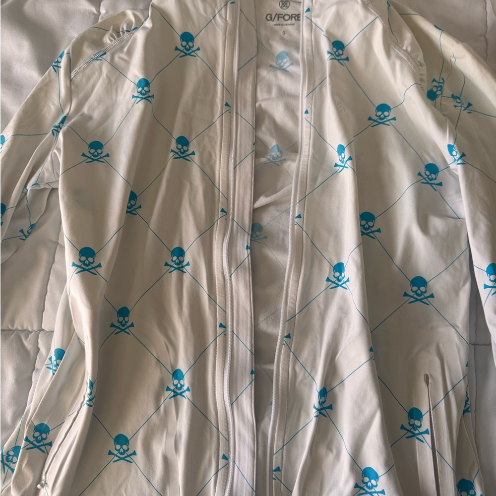 G/FORE White Jacket with Blue Skull Design